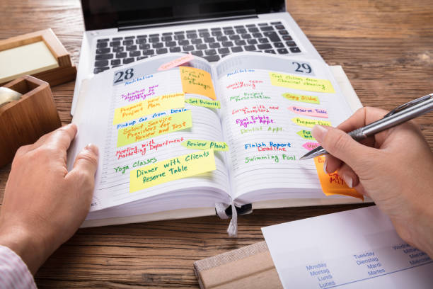 istock Businessperson Looking At List Of Schedule In Diary 908787236