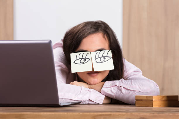 istock Sleeping Businesswoman Covering His Eyes With The Sticky Notes 908787412