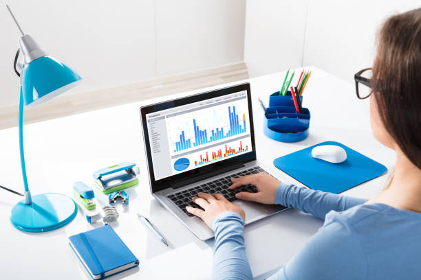 istock Businesswoman Looking At Graph On Laptop 908787622