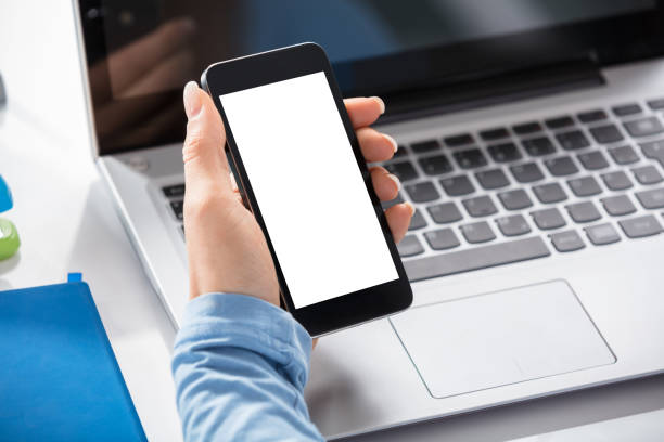 istock Woman Holding Blank Smart Phone In Hand 908793194