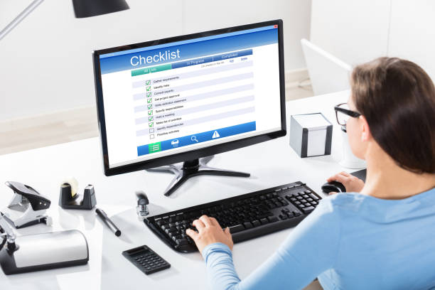 istock Businesswoman Filling Checklist Form On Computer 908793202