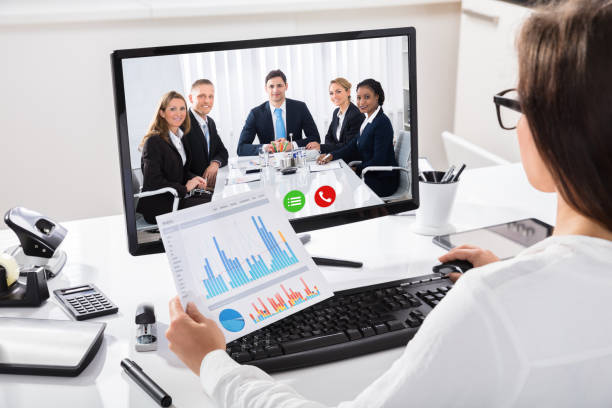 istock Woman Discussing Graph With Her Colleagues On Video Conference 908793242