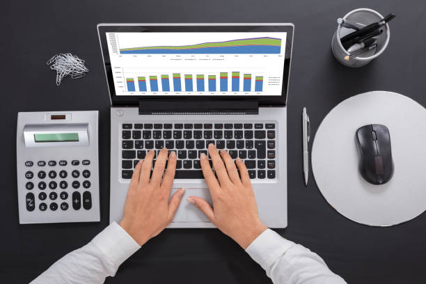 istock Businesswoman Analyzing The Graph On Laptop 908793336