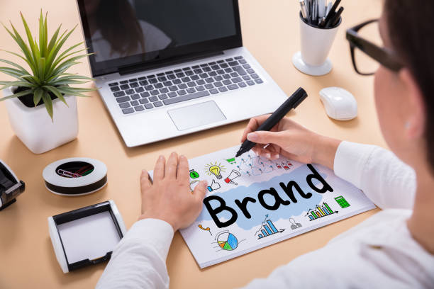 istock Businesswoman Drawing Brand Chart On Office Desk 908793404