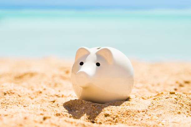 istock White Piggy Bank On Sand 908794370