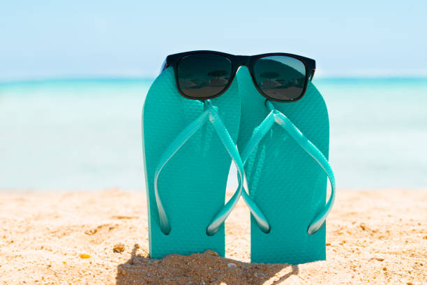istock Sunglasses Over The Turquoise Flip Flop 908794428