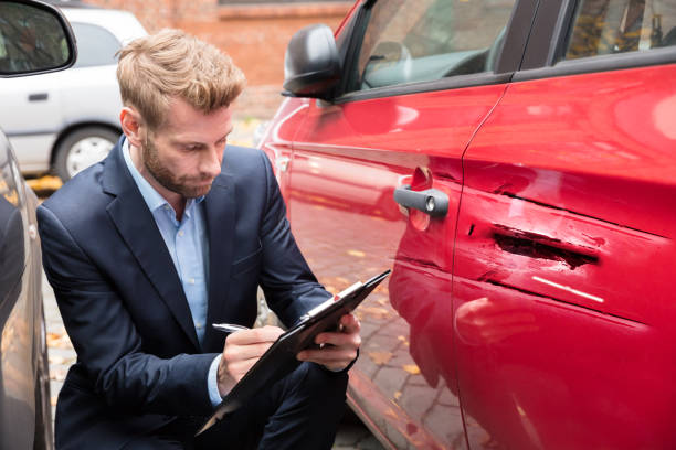 istock Insurance Agent Examining Car After Accident 908800970