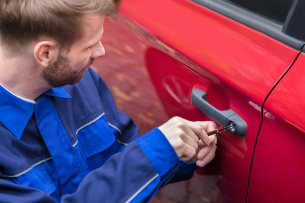 istock Human Hand Opening Car's Door With Lockpicker 908801638