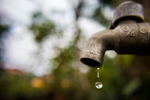 istock Close-Up Of Water Dripping From Faucet 908801700