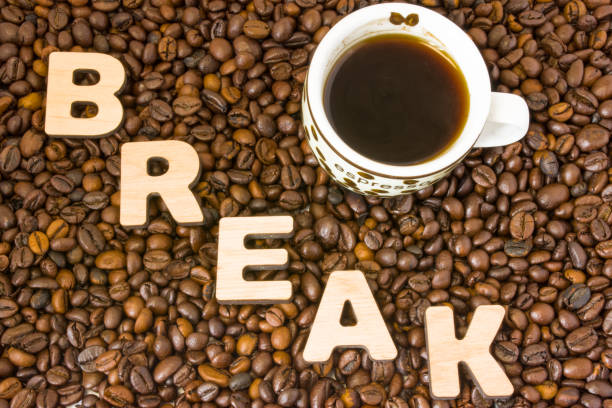 istock Visualization of the concept or action Coffee Break. Word break, which is lined with large, 3D letters, lies in scattered roasted beans coffee near small mug, which is brewed flavored drink 908816284