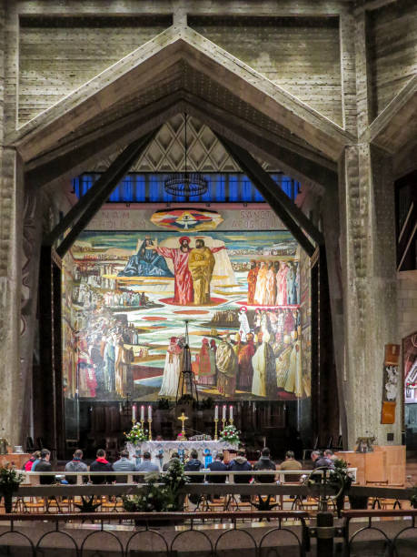 The Basilica of the Annunciation, Nazareth, Israel Nazareth, Israel - December 27, 2017: People are visiting the Interior of the Basilica of the Annunciation, the site where the Archangel Gabriel announced the future birth of Jesus to Mary tomb of the virgin mary in jerusalem stock pictures, royalty-free photos & images