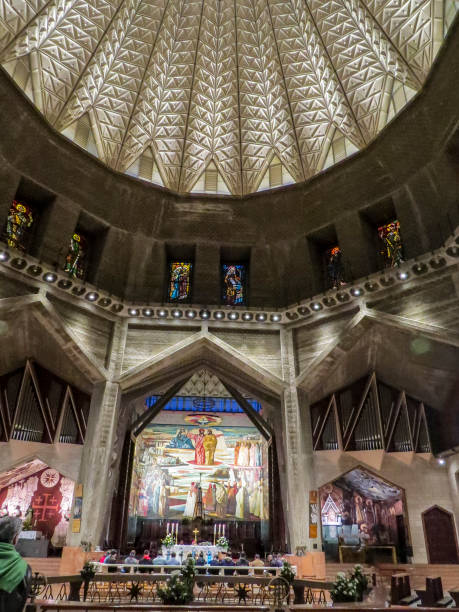 The Basilica of the Annunciation, Nazareth, Israel Nazareth, Israel - December 27, 2017: People are visiting the Interior of the Basilica of the Annunciation, the site where the Archangel Gabriel announced the future birth of Jesus to Mary tomb of the virgin mary in jerusalem stock pictures, royalty-free photos & images