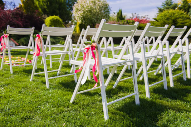 istock White chairs with pink and peach colors ribbons 908821640