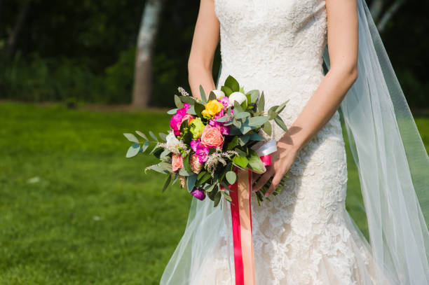 istock Wedding bouquet in bride hands 908821760