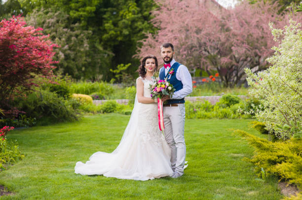 istock Bride and groom posing in beautiful garden 908821958