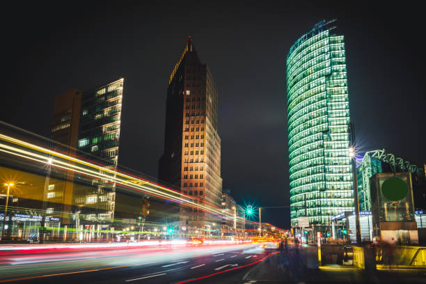 Business city center in Berlin at night. Potsdamer Platz in Berlin. Bahnhof Potsdamer Platz translates as train station Potsdamer Platz. Long exposure photo. City street with night illumination in Berlin, Germany