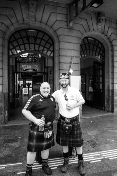 Penicuik Tartan Army - Scotland national football team members fan smiling posing Luxembourg: Penicuik Tartan Army - Scotland national football team members fan smiling posing a beer front Luxembourg central Train station - fans of the Scotland national football team tartan army stock pictures, royalty-free photos & images