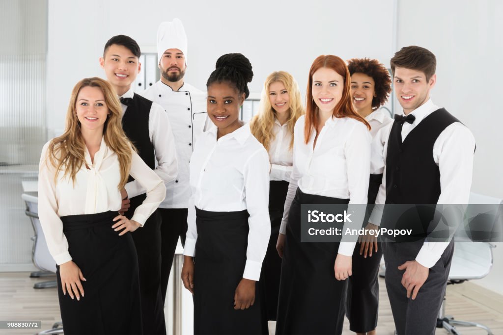 Portrait Of Confident Restaurant Staff Portrait Of Confident Restaurant Staff Standing Against White Background Hotel Stock Photo