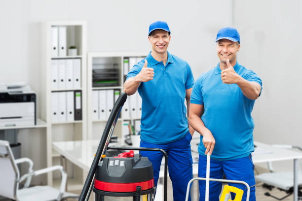 istock Two Cleaners Standing With Cleaning Equipments 908830782