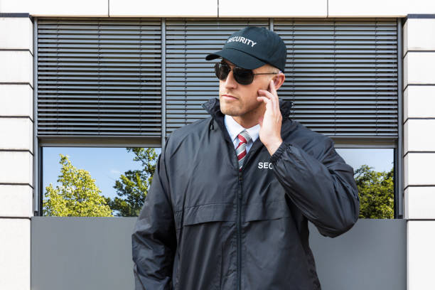istock Security Guard In Front Of The Door Entrance 908833598