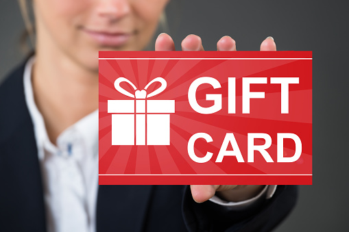 Closeup Of Woman's Hand Holding Gift Card