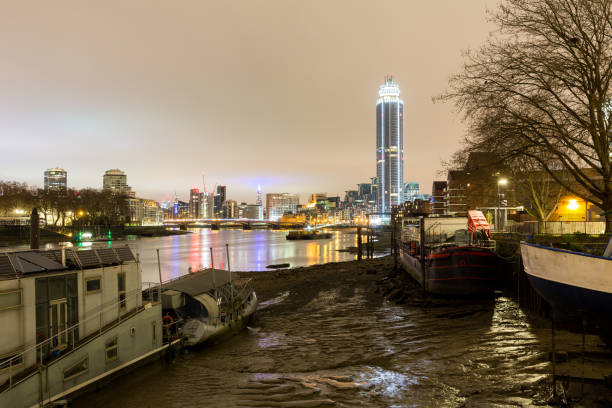 Houseboats on Thames River and the London Skyline. stock photo