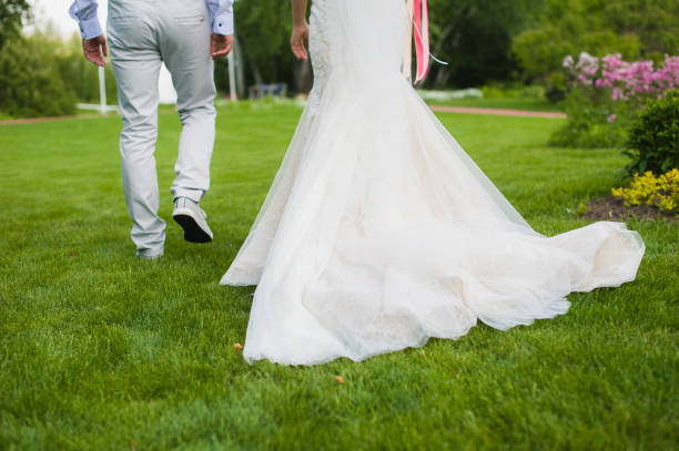Beautiful bride with her husband in the park. Background of yellow tree. Happy couple.