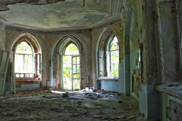 Old room with rotten window and doorway of an abandoned castle of Khvostov in gothic style, Lipetsk region
