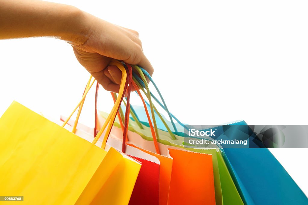 Five colorful paper shopping bags on a white background A woman hand carrying a bunch of colorful shopping bags Paper Bag Stock Photo