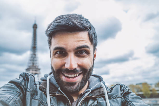 istock Young man taking selfie with smartphone 908840750