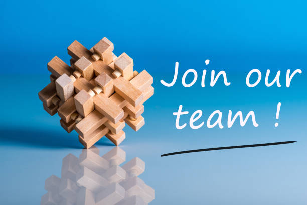 istock Job recruiting advertisement represented by 'JOIN OUR TEAM' texts on blue background with wooden brain teaser talking about the difficult tasks, new challenges and opportunities 908849162