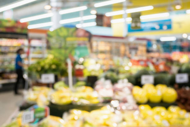 istock Supermarket grocery store with fruit and vegetable on shelves blurred background 908850536