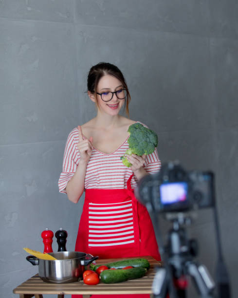 istock Young redhead woman making cooking video for social network 908850800