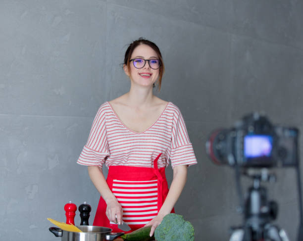 istock Young redhead woman making cooking video for social network 908850802