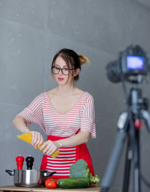 istock Young redhead woman making cooking video for social network 908850808