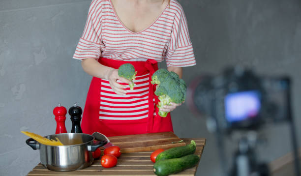 istock Young redhead woman making cooking video 908850812