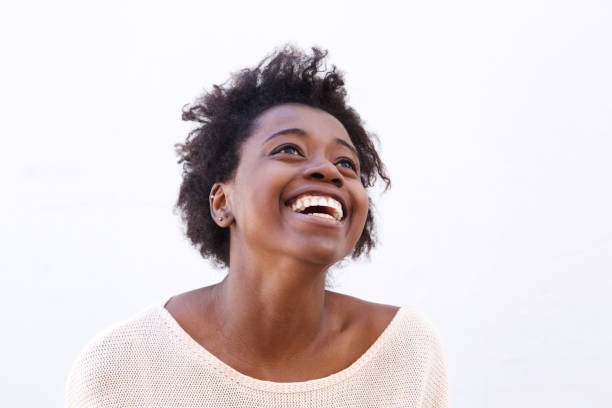 istock Young black woman looking up and laughing 908850904