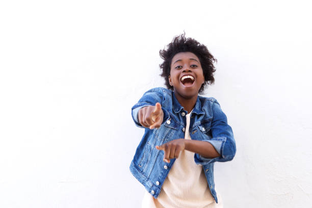 istock Cheerful young black woman pointing fingers 908850926
