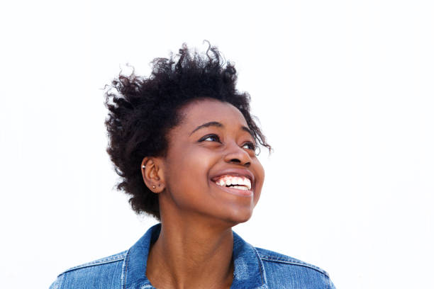 istock Smiling young black woman looking away at copy space 908850930