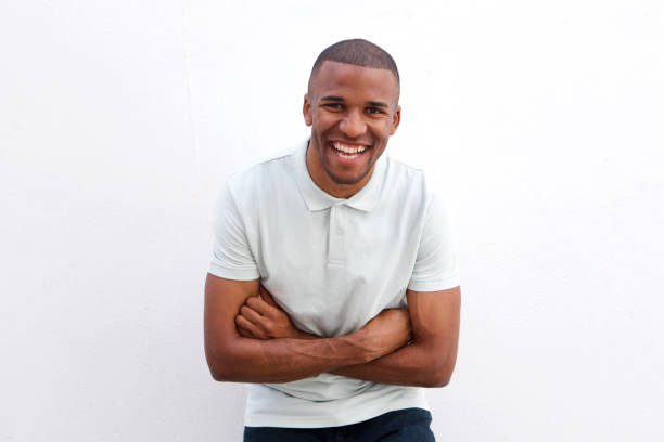 istock young african man standing with arms crossed 908851252