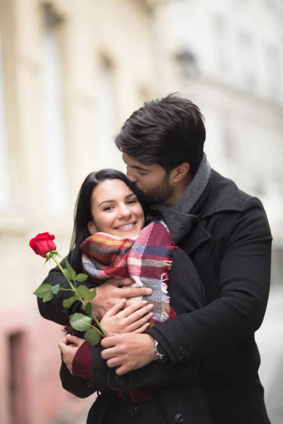 istock Young man kissing his girlfriend 908851506