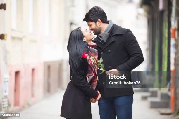 Young Beautiful Couple Kissing On The Street Stock Photo - Download Image Now - Couple - Relationship, Winter, Valentine's Day - Holiday