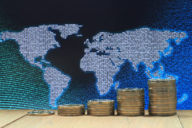 istock World of idea. Coin pile stacked in increasing chart shape on wood board with White dots grid pattern world map on digital blue and green color dot. 908859638
