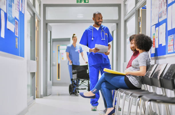 istock relaxed doctor with pregnant couple 908860330