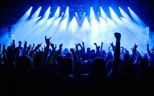 istock Crowd raising hands in the air on concert 908862618