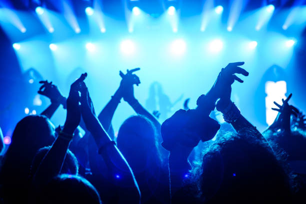 istock Crowd raising hands in the air on concert 908862774