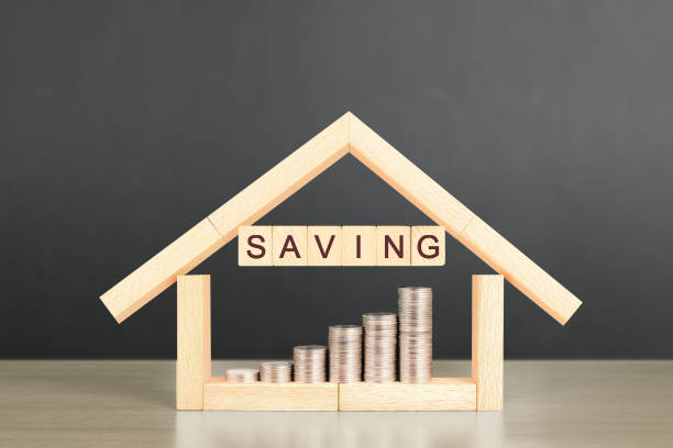 istock Mortgage concept by house from  hand 908863116