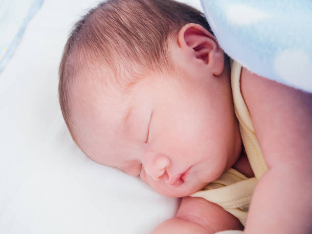 istock Newborn baby girl sleeping 908868020