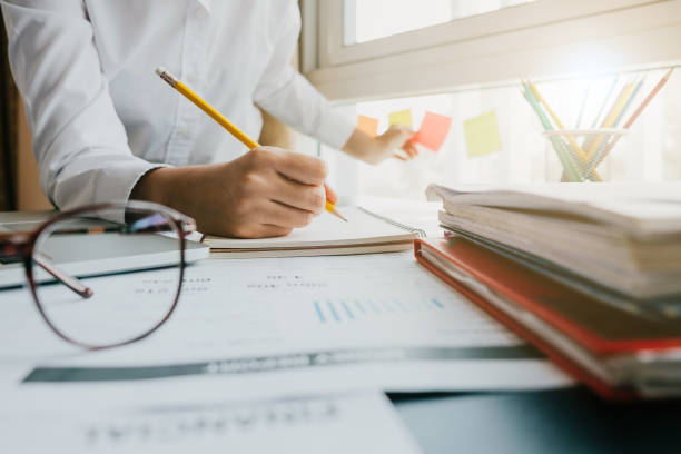 istock Close up business woman taking note in notebook for business schedule 908868372