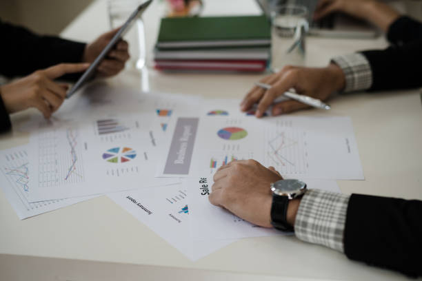 istock Hand of business man while is working look graph. is discussing together in conference room talk about Report, Sales, Marketing, Concept 908871194